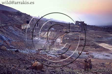 Old installations of opencast mining Zaranda-Naya at dawn. Chimneys in the foreground. Huelva. SPAIN     / 7.4-81